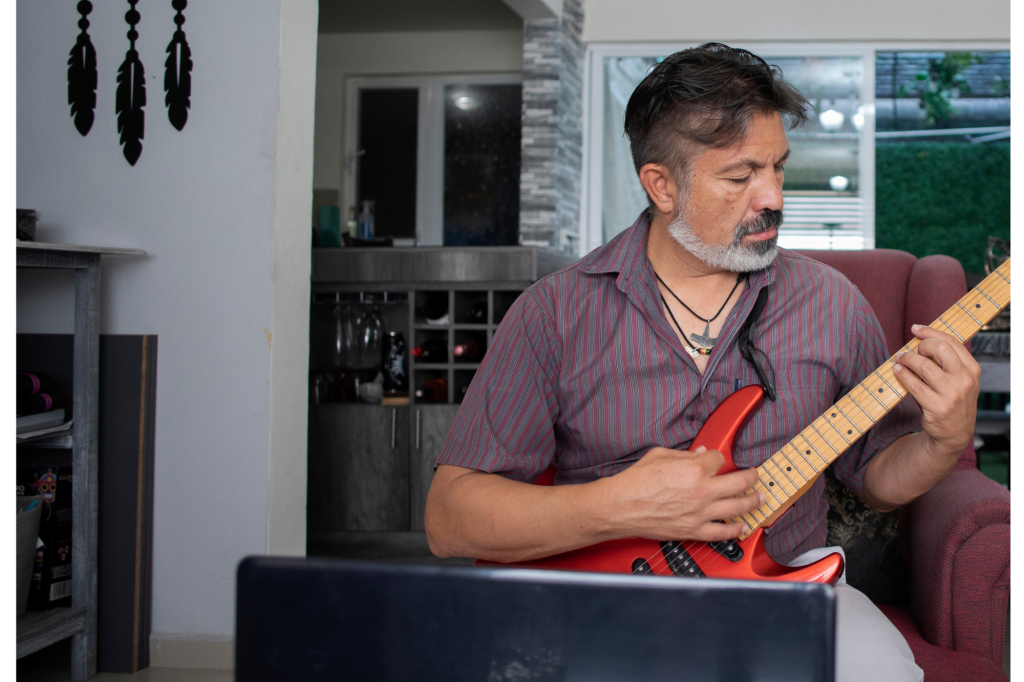 retired man taking guitar lessons 