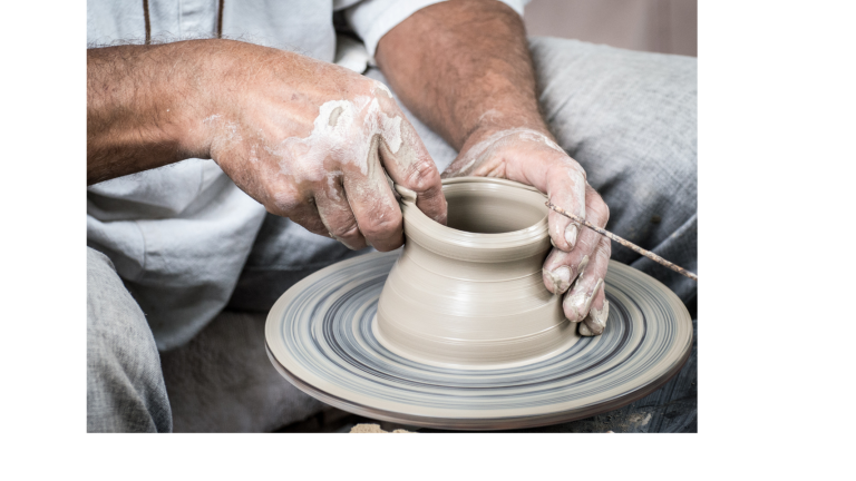 man learning pottery